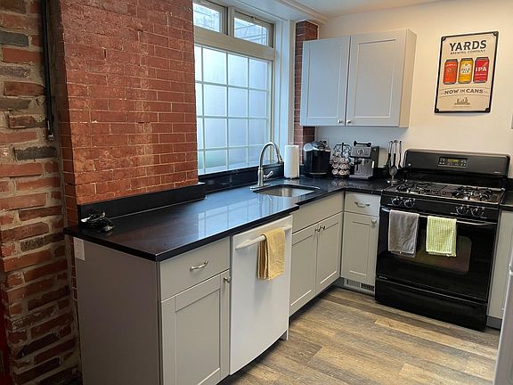 South facing windows in kitchen & bathroom; (small, paved) gated yard on other side of windows.