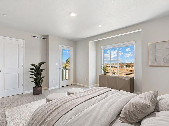 The master bedroom is spacious and has access to a deck.