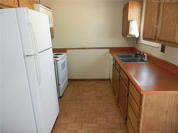Galley style kitchen with eat-in area, walk-out to back yard and appliances stay