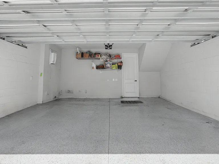 Large 2-car garage with built in storage on wall and over garage door