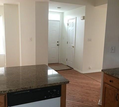 Looking from the Kitchen to main door, dining room on left and Powder Room. 
Powder Room is on the left and the coat closet on the right when you enter the home.