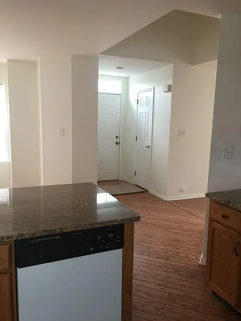 Looking from the Kitchen to main door, dining room on left and Powder Room. 
Powder Room is on the left and the coat closet on the right when you enter the home.
