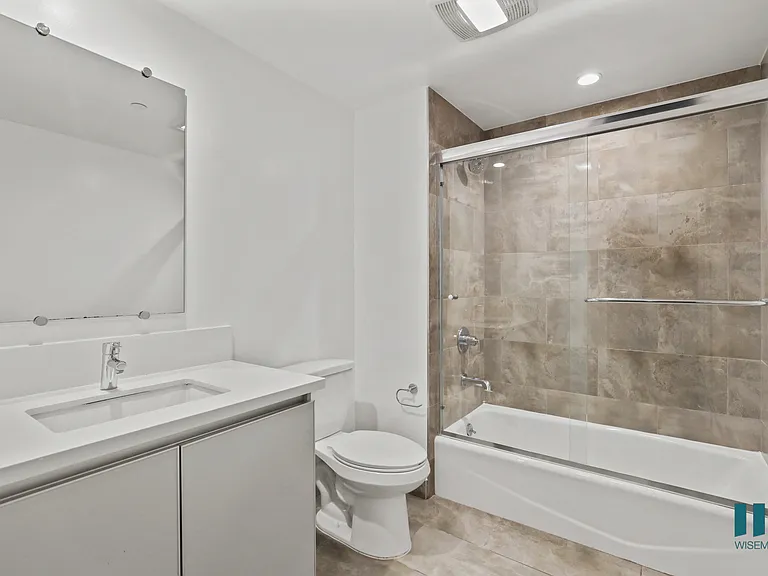 Bathroom with Shower Bath with Glass Door and Vanity Cabinet Storage
