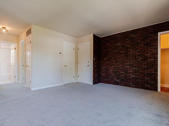 Living Room showing closet and hallway leading to bathroom.