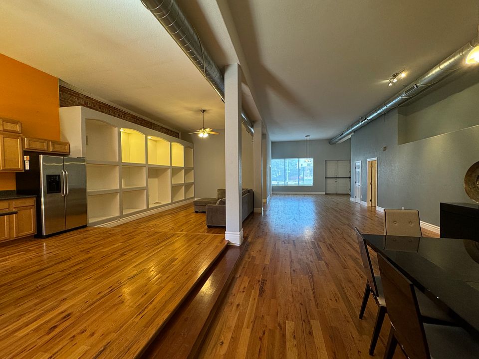 View from back overlooking dinning room, kitchen and great room with front windows/ front door in background.