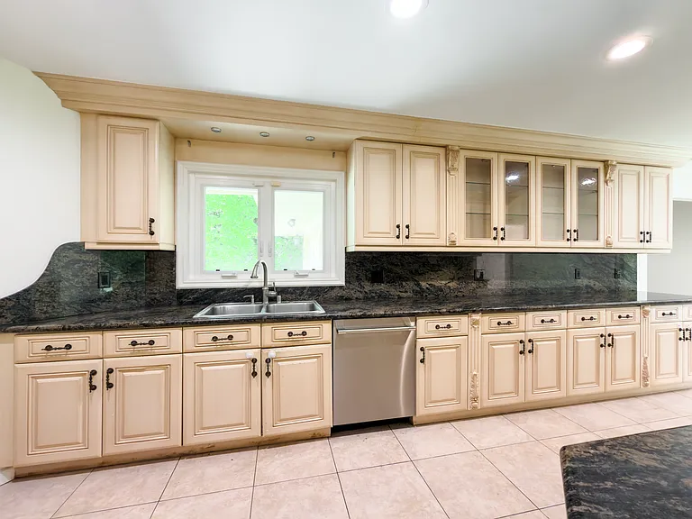 Kitchen window above the sink frames a garden view, adding charm to this Beverly Hills luxury rental at 1094 Garden Lane, a 90210 home for rent.