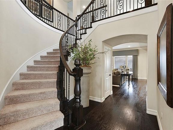 THE SWEEPING STAIRCASE FEATURES UPGRADED IRON BALUSTERS AND LEADS TO A LARGE GAME ROOM!