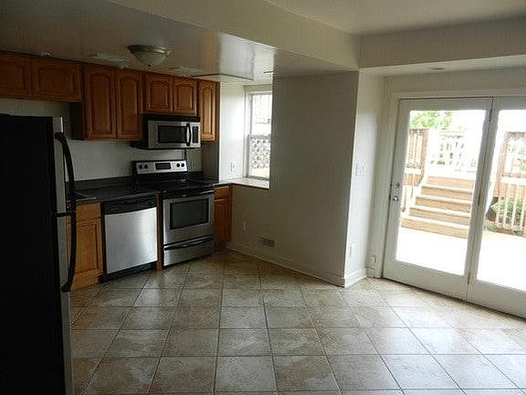 fully equipped, large eat in kitchen with travertine flooring