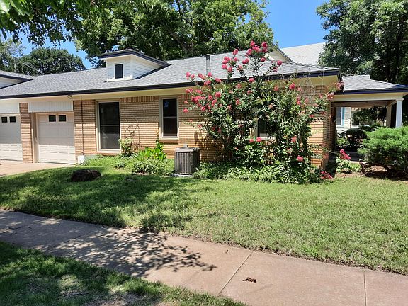 South facade with garage access.