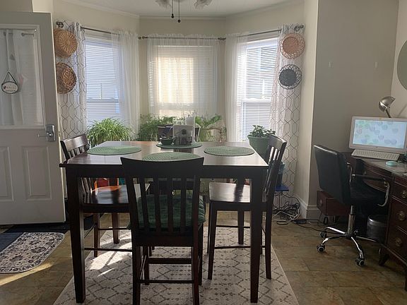 Open plan dining area with lots of light from the bay window. Wide entry into living room and space for a buffet or desk/workstation.