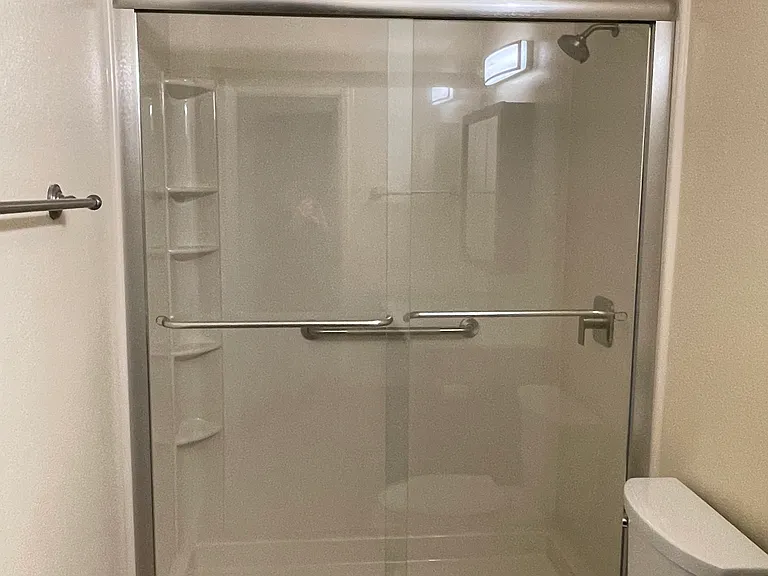 Brand new step in shower with satin nickel fixtures.