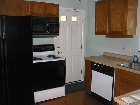 Equipped kitchen.  Wood flooring, lots of cabinets.  Door leading to deck.