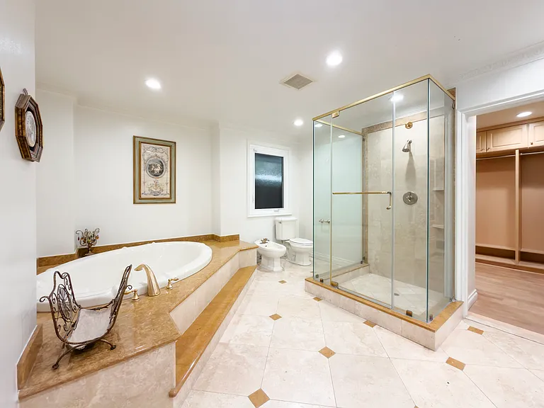 Glass-enclosed walk-in shower and a deep soaking tub create a spa retreat in this Beverly Hills luxury rental at 1094 Garden Lane, a 90210 lease.