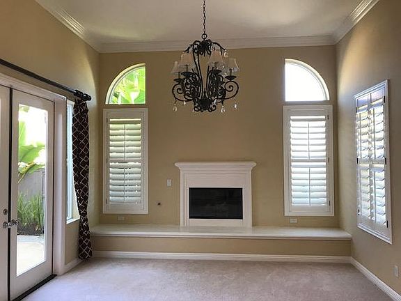 Living room w/gas fireplace, chandelier, courtyard access