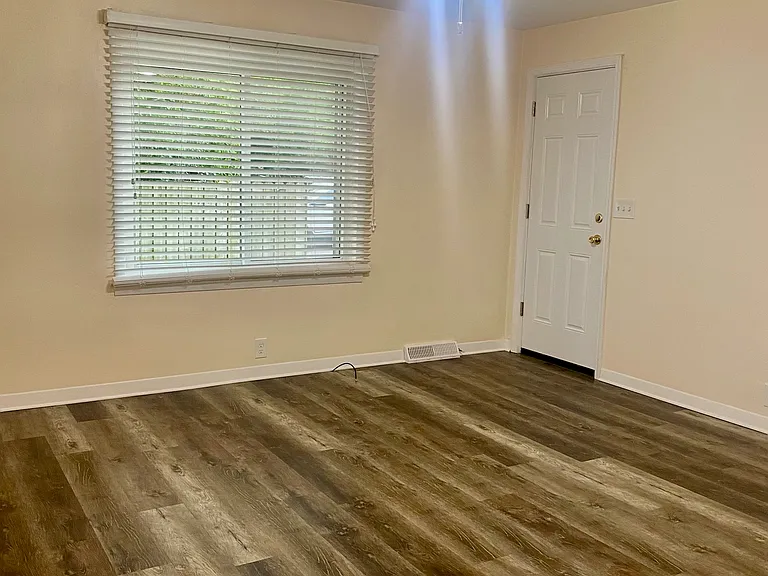 Living room with back door to the basement
