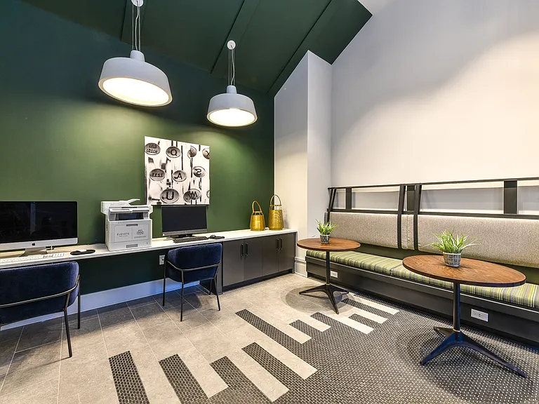 The business center is equipped with computers and a printer.