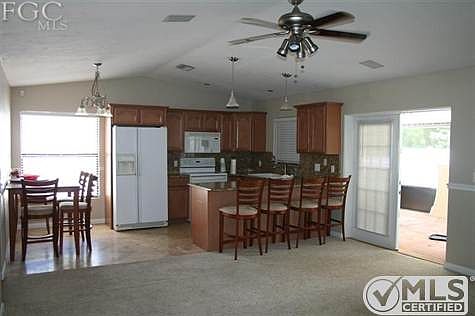 Remodeled kitchen with granite countertops. French doors to lanai & pool area!