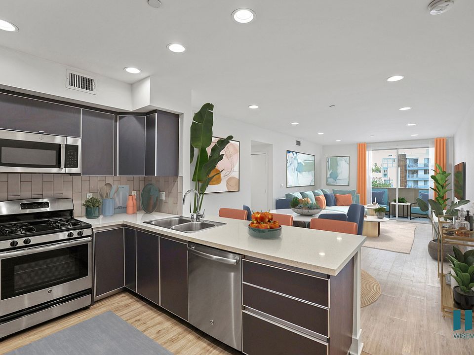 Open-Concept Kitchen, Dining, and Living Room with Patio