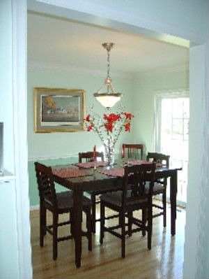 dining room w/wood floors leading to deck and kitchen