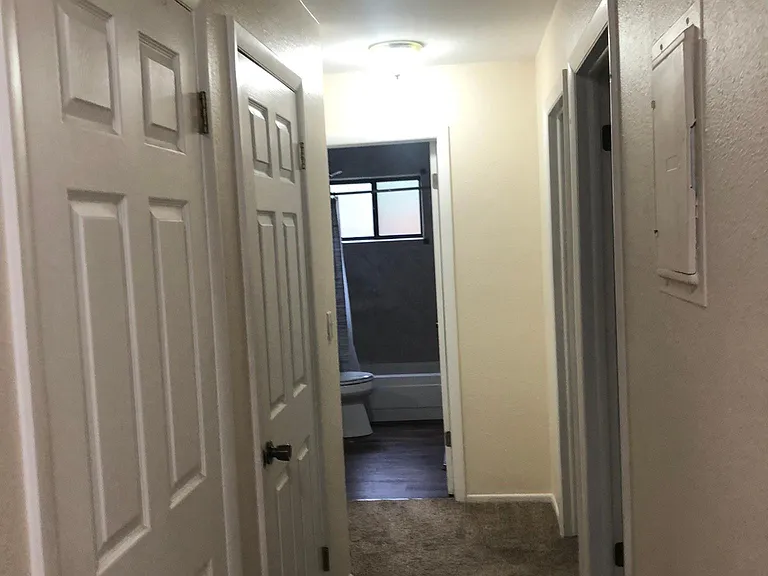 Upstairs Hallway Showing Hall Coat Closet and Pantry and Bathroom and Doorways to Bedrooms.