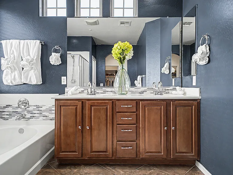 The spacious primary bathroom features a large soaking tub (without jets) and a connected enclosed walk-in shower, creating a comfortable and relaxing retreat.