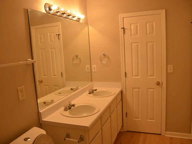 Master bathroom with Double Vanity and entry to walk-in closet