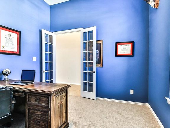 Study with double french doors, located off entry