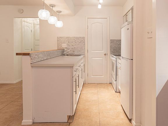 View of the galley kitchen and kitchen pantry.
