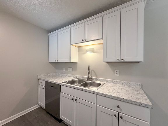 Newly remodeled kitchen with sleek countertops, stainless steel appliances, and ample storage space