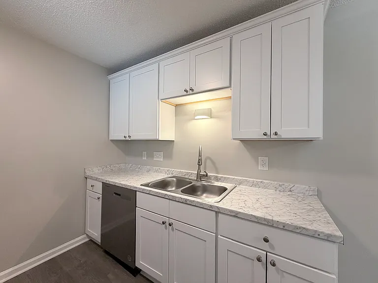 Newly remodeled kitchen with sleek countertops, stainless steel appliances, and ample storage space