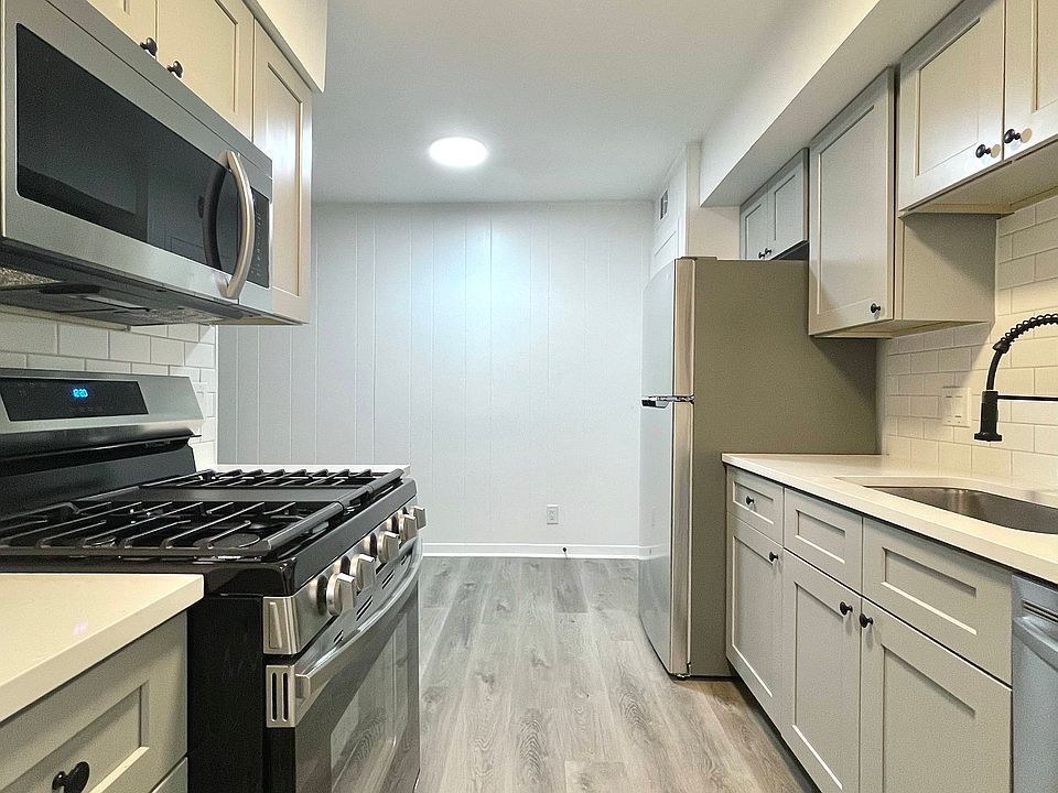 Remodeled kitchen with stainless steel appliances, quartz counters