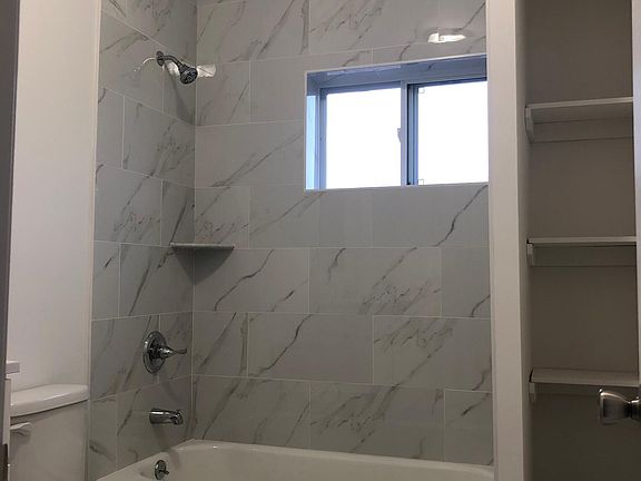 Full bathrooms with shelving.