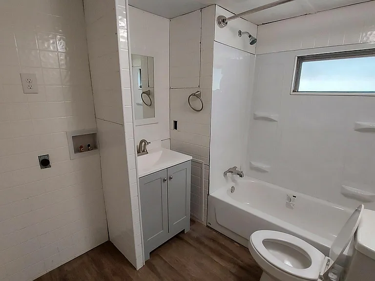 Main Bathroom located in hallway with stackable washer and dryer hookup.