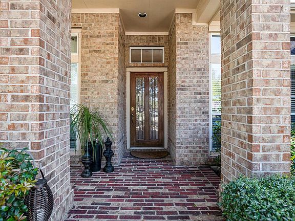 A delightful front covered porch greets you as you walk up to the dual paned glass and wood front door.