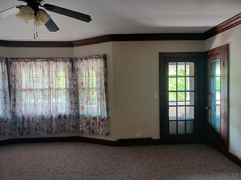 Living room has large storage closet by front porch door.