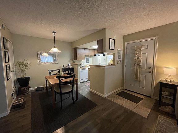 Entry way, dining room, and view of kitchen