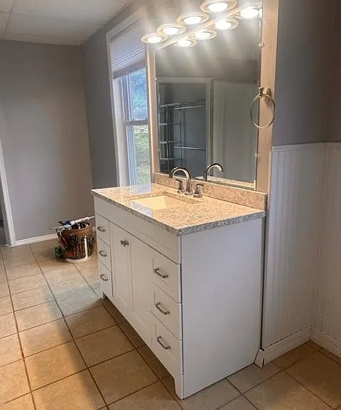 Newly updated bathroom almost completed. New vanity, sink fixtures and mirror.
