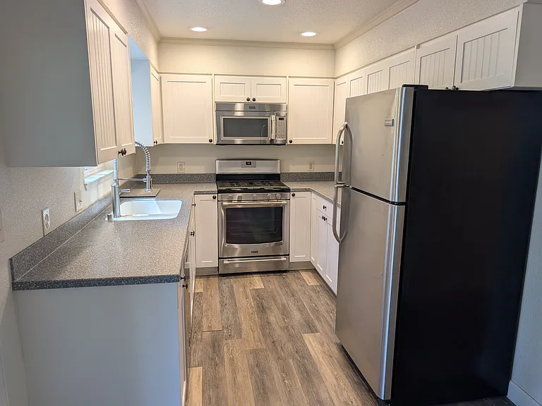 Kitchen with newer cabinets, appliances, and custom counter tops