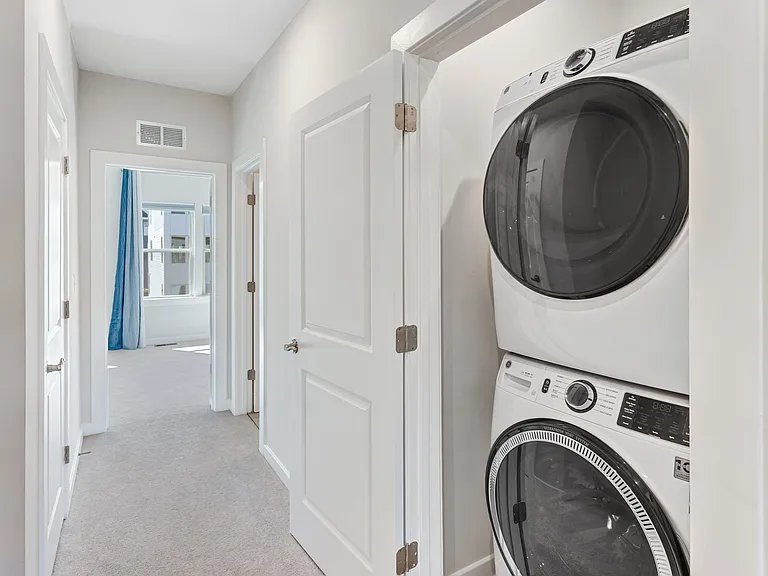 Enjoy the convenience of a smart washer and dryer on the bedroom level, thoughtfully placed to simplify everyday living.