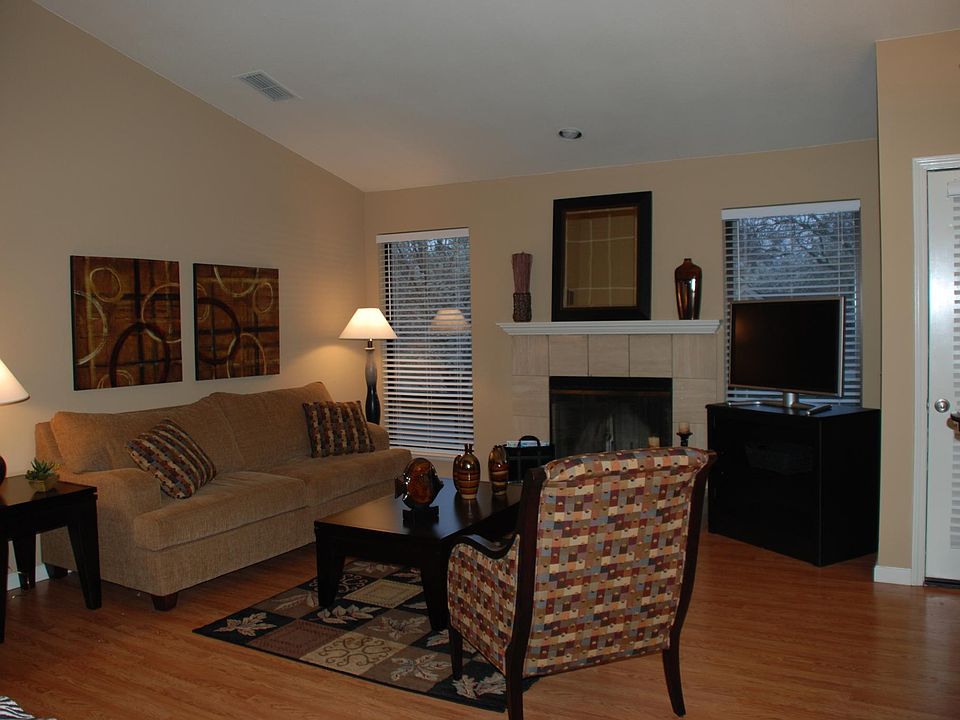Spacious Living Area with wood burning fireplace.
