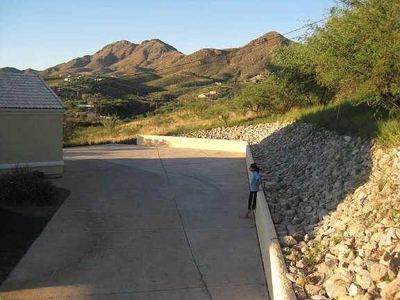 A view of the rocks bank that borders the driveway