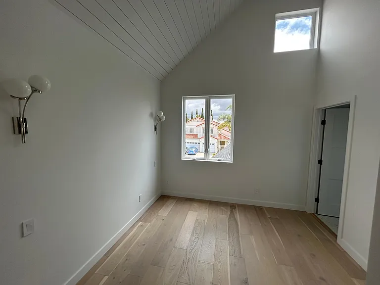 Bedroom with oversized windows high ceilings and walk-in closet