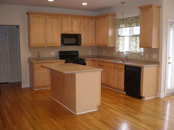 Open kitchen with gas range and window over the sink