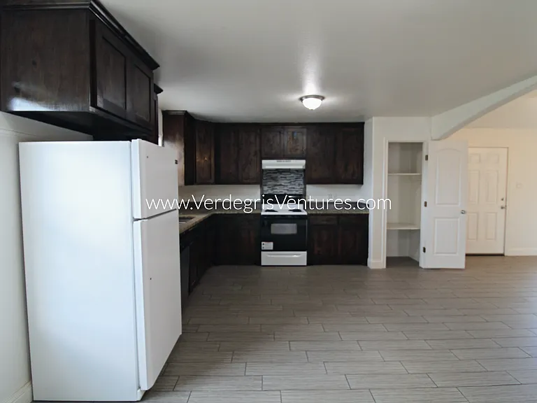 A spacious, open_concept layout connecting the kitchen, living, and dining areas.