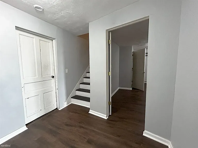 Bottom of stairway showing laundry room and entrance to office/bonus room