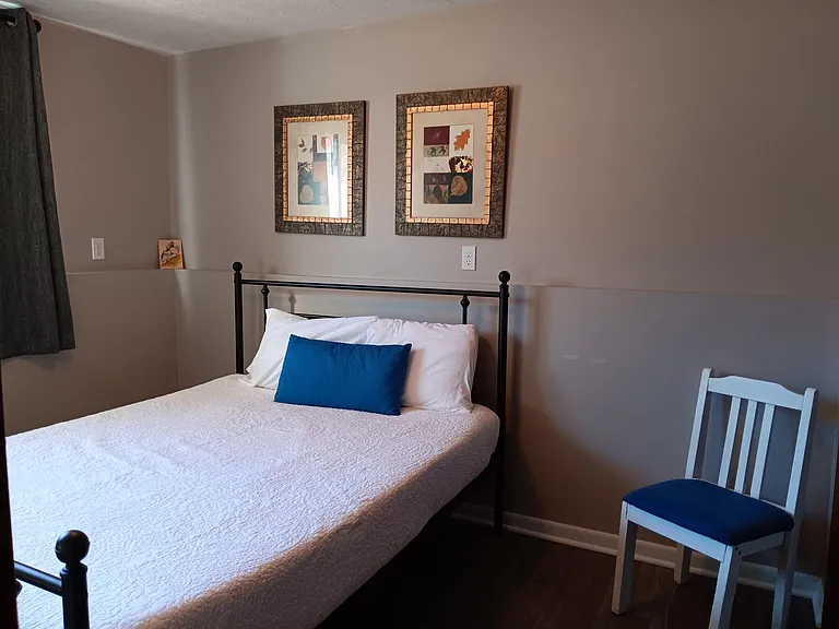 Downstairs bedroom with large window and closet.