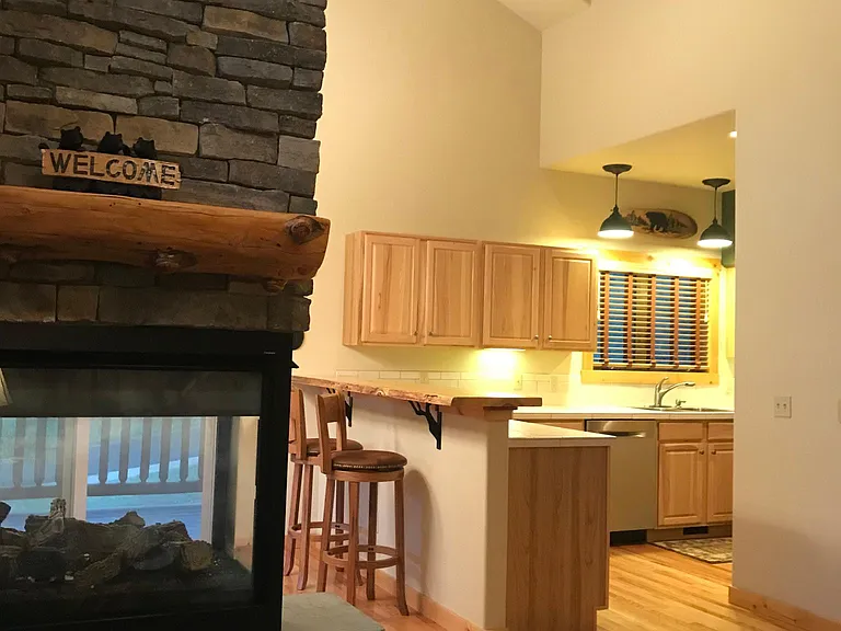 3-sided stone fireplace/Bar w/included bar stools/Kitchen