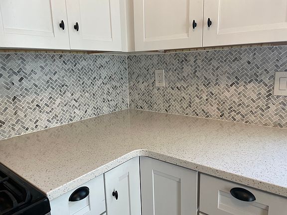 Quartz counters and marble backsplash