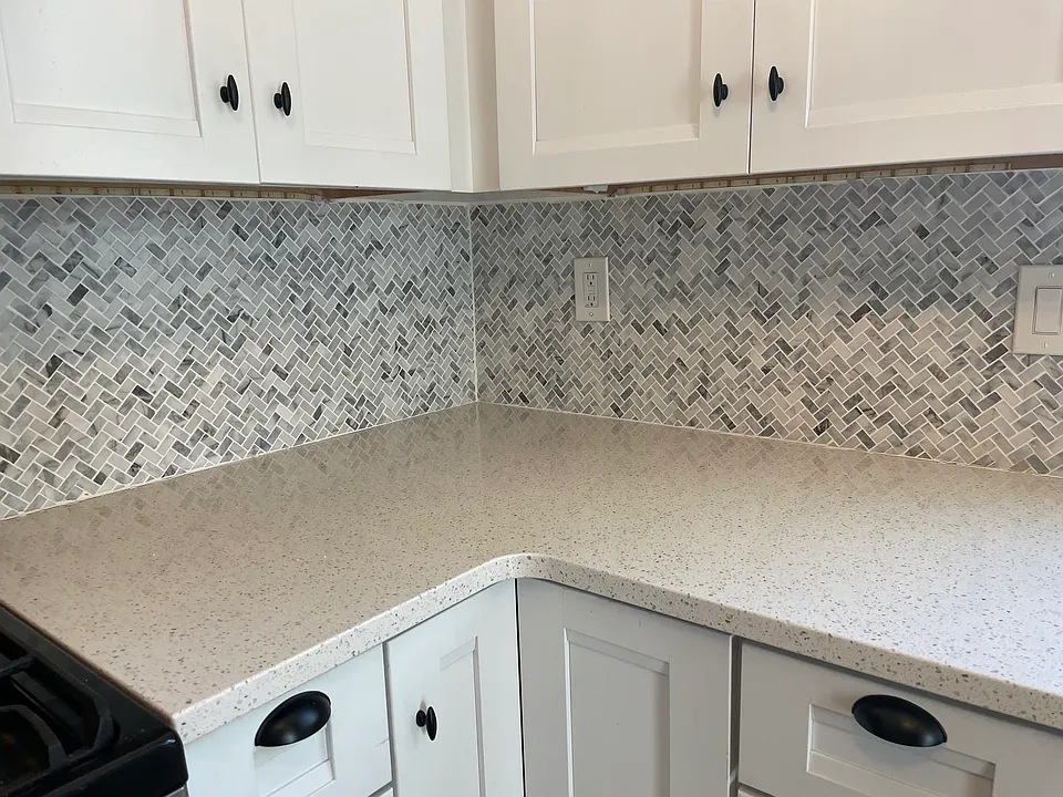 Quartz counters and marble backsplash