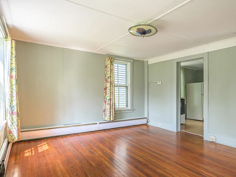 Three professional photos made pre-improvements on a less dreary day give better sense of scale and light in living room.
